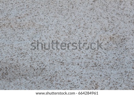Small sand stone of sand wall texture. Natural grey sand stone for design with copy space for text or image. background of sand with raindrops.