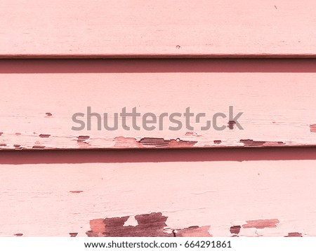 Pink tinted weathered pastel wall with peeling paint