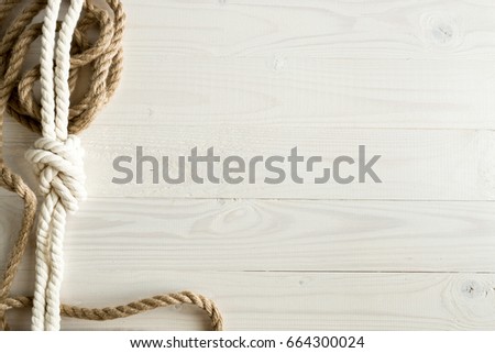 Closeup image of ship ropes on white wooden background