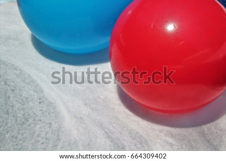 Red and Blue Balls Floating on Bubbles Horizontal