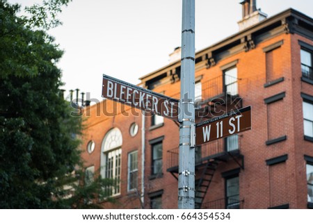 New York City street signs at the junction of Bleecker Street and 11th in Greenwich Village.