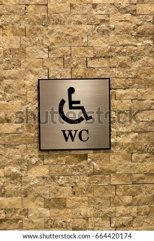 Toilet sign. Textured marble wall. The symbol of the male and female toilet.