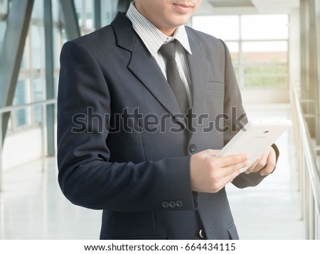 Businessman using his tablet in the office