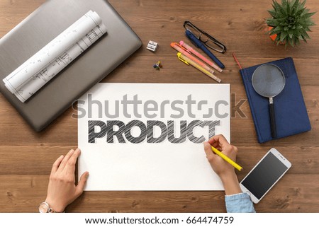 Girl draw text Product and get it on paper sheet at the table with a mobile phone, a laptop, business accessories