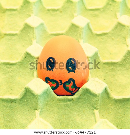 Christmas egg with faces drawn arranged in carton