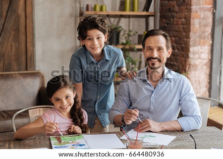 Lovable family posing near the table in living room