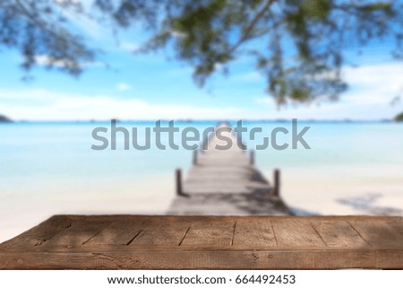 Empty wood table top and blue sky with seascape background. For product display montage.