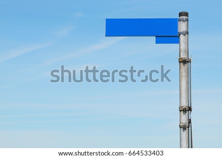 blank road sign against blue sky