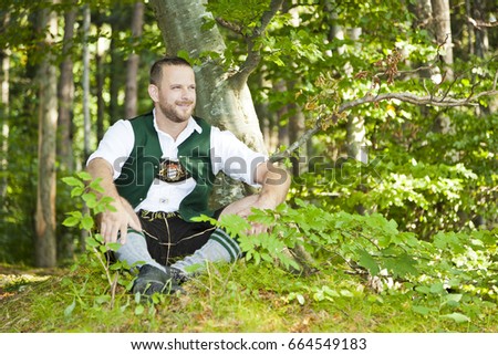 An image of a traditional bavarian man in the green forest