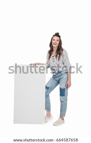 young smiling woman standing and holding empty banner, isolated on white
