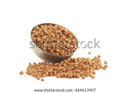 metal bowl of buckwheat isolated on white background