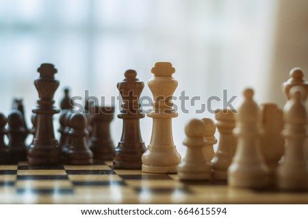 chess black and white pieces on the wooden Board