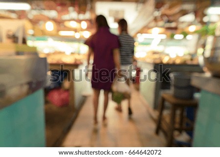 Abstract blur image of people in food market for background usage