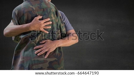 Digital composite of Back of soldier hugging against grey wall