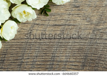 White roses on the wooden table. Fresh flowers. Greeting card.