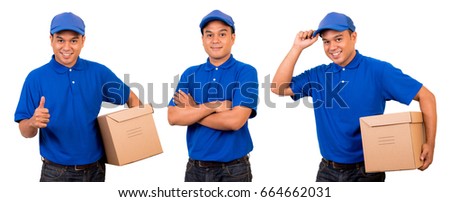 Young asian delivery man in blue uniform with parcel cardboard box on isolated Royalty-Free Stock Photo #664662031