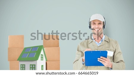 Digital composite of Smiling delivery man holding clipboard by house and parcels