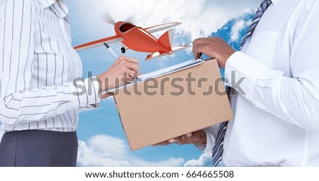 Digital composite of Midsection of delivery man taking sign of woman while delivering parcel with airplane in background