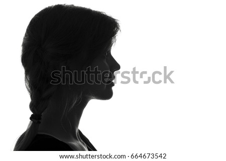 Black and white fashion portrait profile silhouette of face of a beautiful young woman with a hairstyle on her head