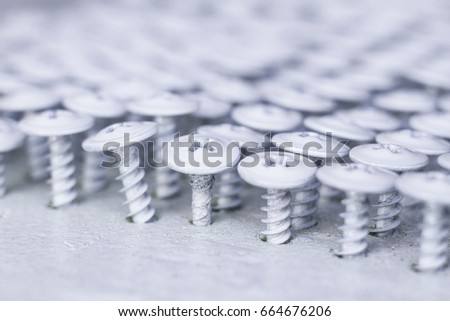 White screws on a blurry background