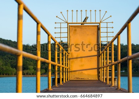 Yellow iron gate on the bridge