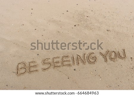 Handwriting  words "BE SEEING YOU." on sand of beach.