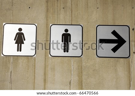 Couples this way - restroom signs on concrete wall