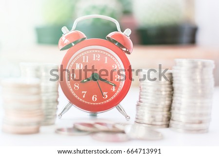Red old fashioned alarm clock on time to work at make money, vintage soft filter.