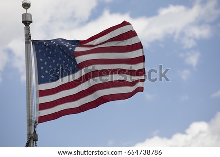 American flag waving blue sky background