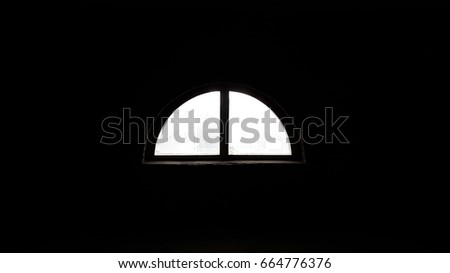 Lonely window on the background of a black wall