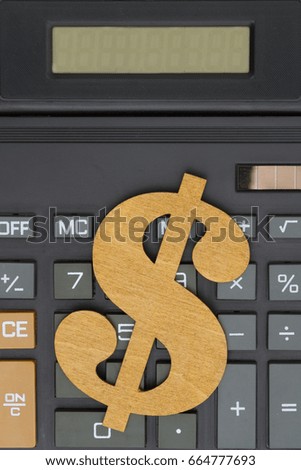 Close-up of a calculator with a dollar sign and large display
