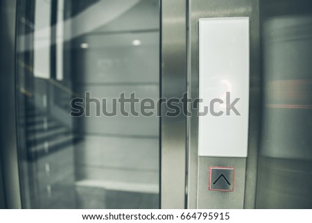 modern glass elevator control panel. go up