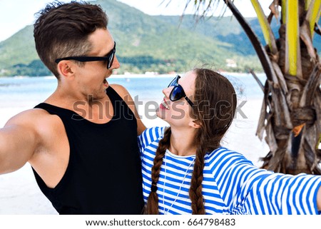 Young pretty couple of young travelers having fun and making selfies in tropical romantic vacation, holidays in paradise island, summer relax.