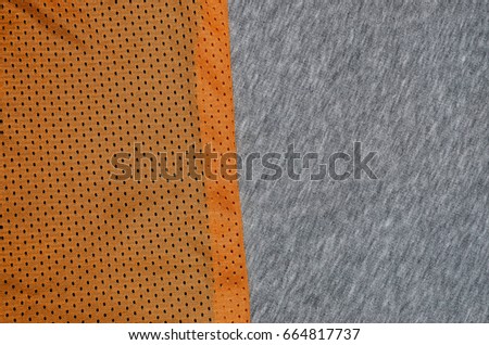 Top view of cloth textile surface. Close-up rumpled heater and knitted fabric texture with a thin striped pattern. Sport clothing fabric texture. Colored basketball shirt and hoodie