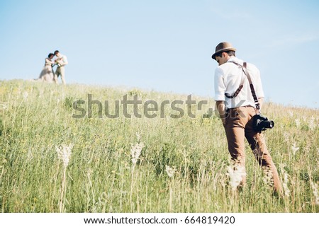 wedding photographer takes pictures of bride and groom in nature in summer, fine art photo