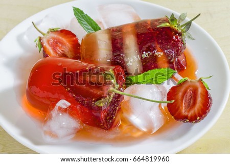 Liquid sweet strawberry jelly in ice cubes