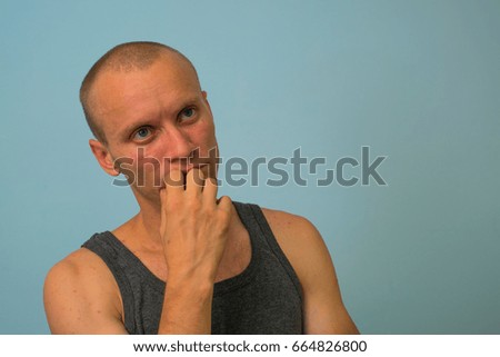 Business man thinking over solving a problem, isolated on a gray background