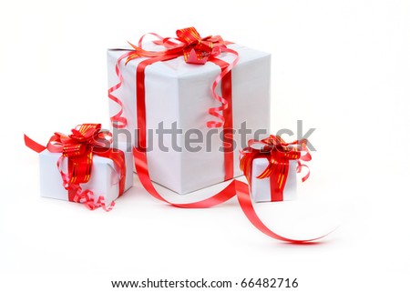 A white box tied with a red satin ribbon bow. A gift for Christmas, Birthday, Wedding, or Valentine's day.