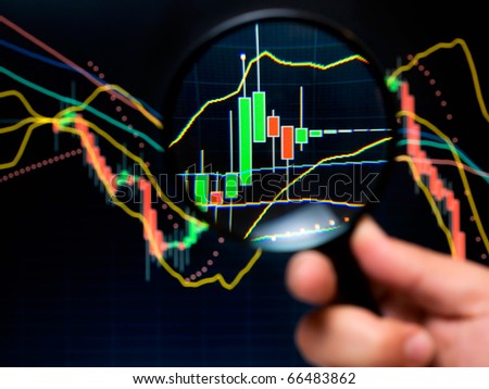 Magnifier and graph, basic tools of technical analysis on the stock market.