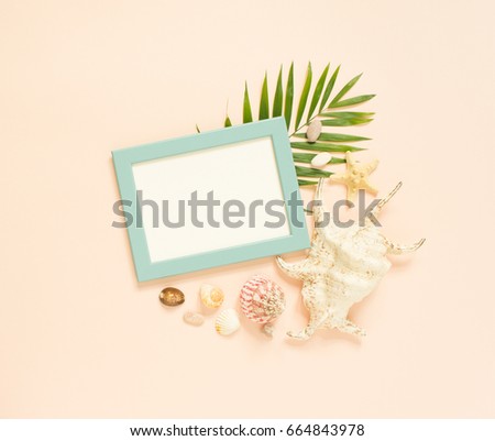 Empty frame and marine items on creme background. Starfish and seashells. Selective focus. Place for text. Flat lay, top view