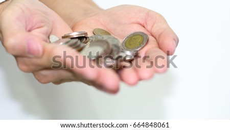 Coins in hands on white background.