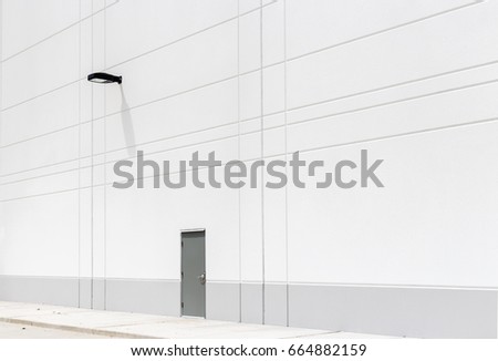 New construction warehouse white walls gray metal back door light fixture