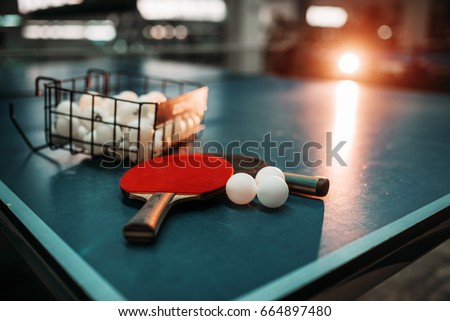 Ping pong table, rackets and balls in a sport hall Royalty-Free Stock Photo #664897480