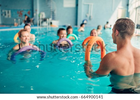 Aqua aerobics, women class with male trainer Royalty-Free Stock Photo #664900141