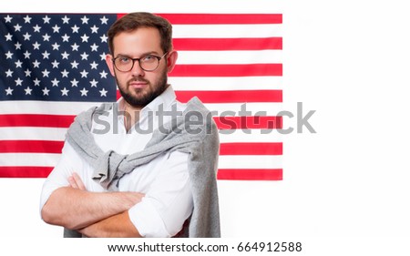 Smiling young man on United States flag background. Student is learning English as a foreign language. American flag