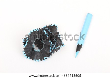 blue pencil and shavings on white paper background