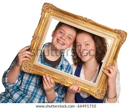 Two teenagers posing holding a picture frame