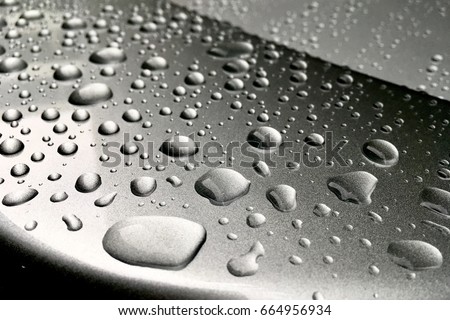 Rain dropped on glass coated of car. Royalty-Free Stock Photo #664956934