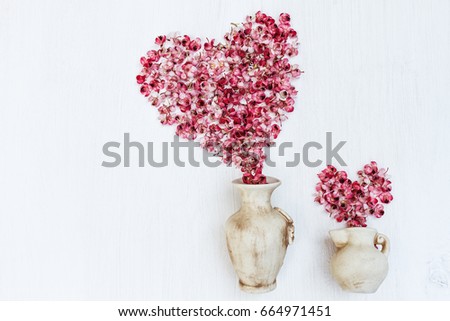 Pink flowers sweetheart stylish in a vintage vase on a white background. Beautiful fantasy romantic minimalist still life. Space for text. Flat lay