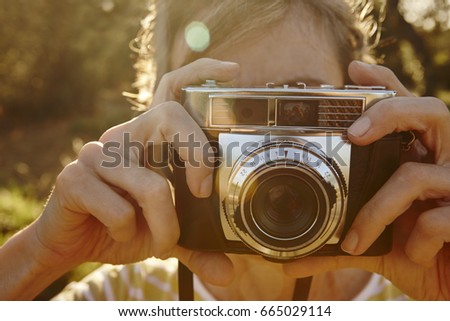Woman taking pictures with vintage camera. Travel background.  